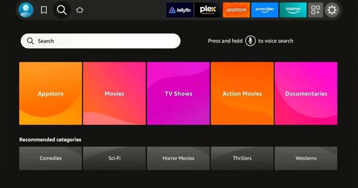 FireStick home screen search bar and category tiles, demonstrating the Find or Search function to locate the Downloader app.