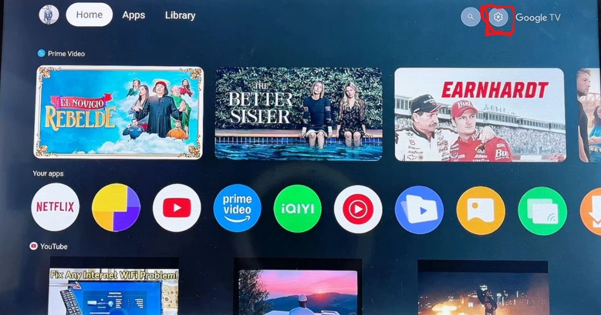A high-quality screenshot showing the TCL TV home screen with the settings gear icon highlighted in the top-right corner to begin the IPTV Smarters Pro installation.